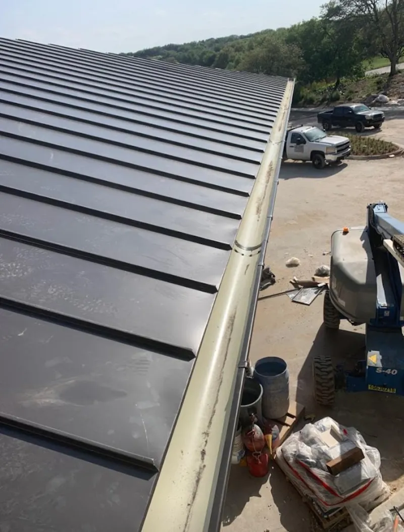 Standing seam panel and gutter detail on a metal roofing jobsite in Spanish Fort